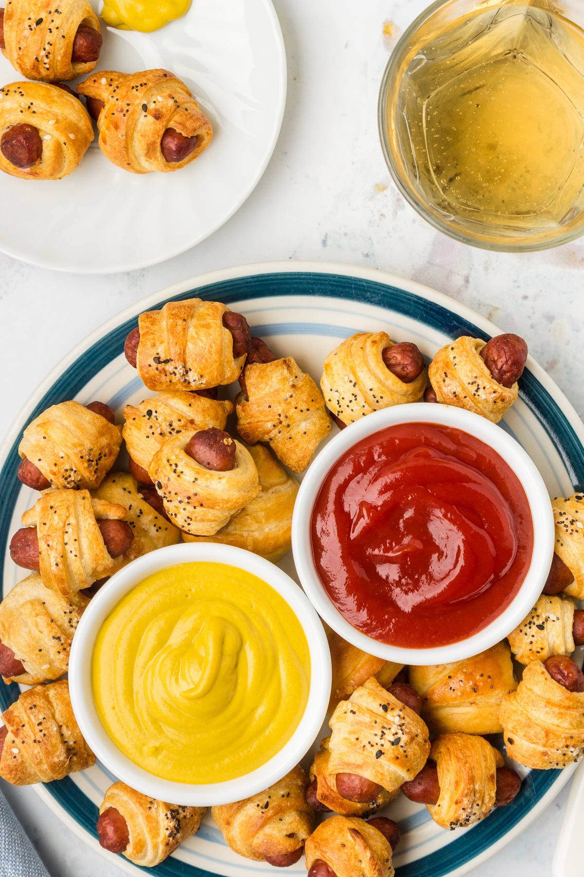 air fryer pigs in a blanket served with ketchup and mustard dipping sauces