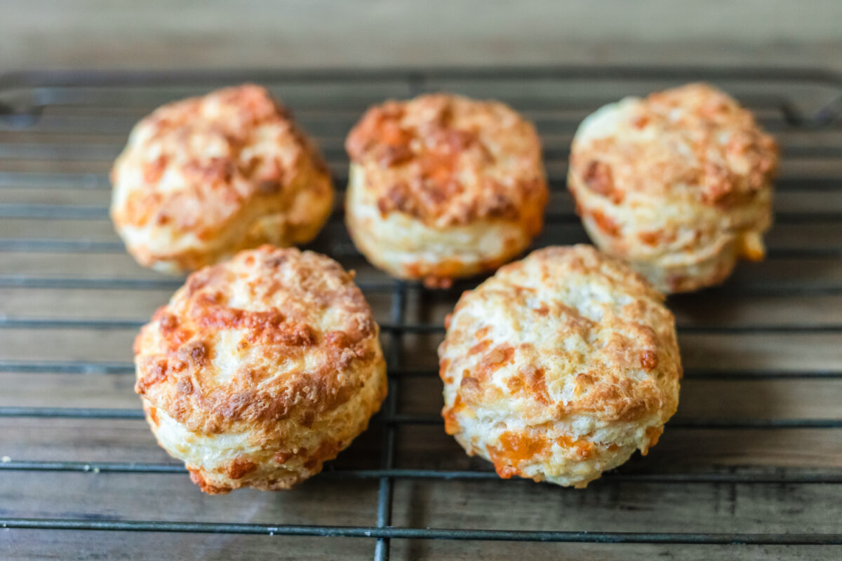 homemade cheese biscuits cooling on a rack